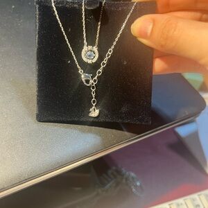 Open box Swarovski dancing heart necklace baby blue.